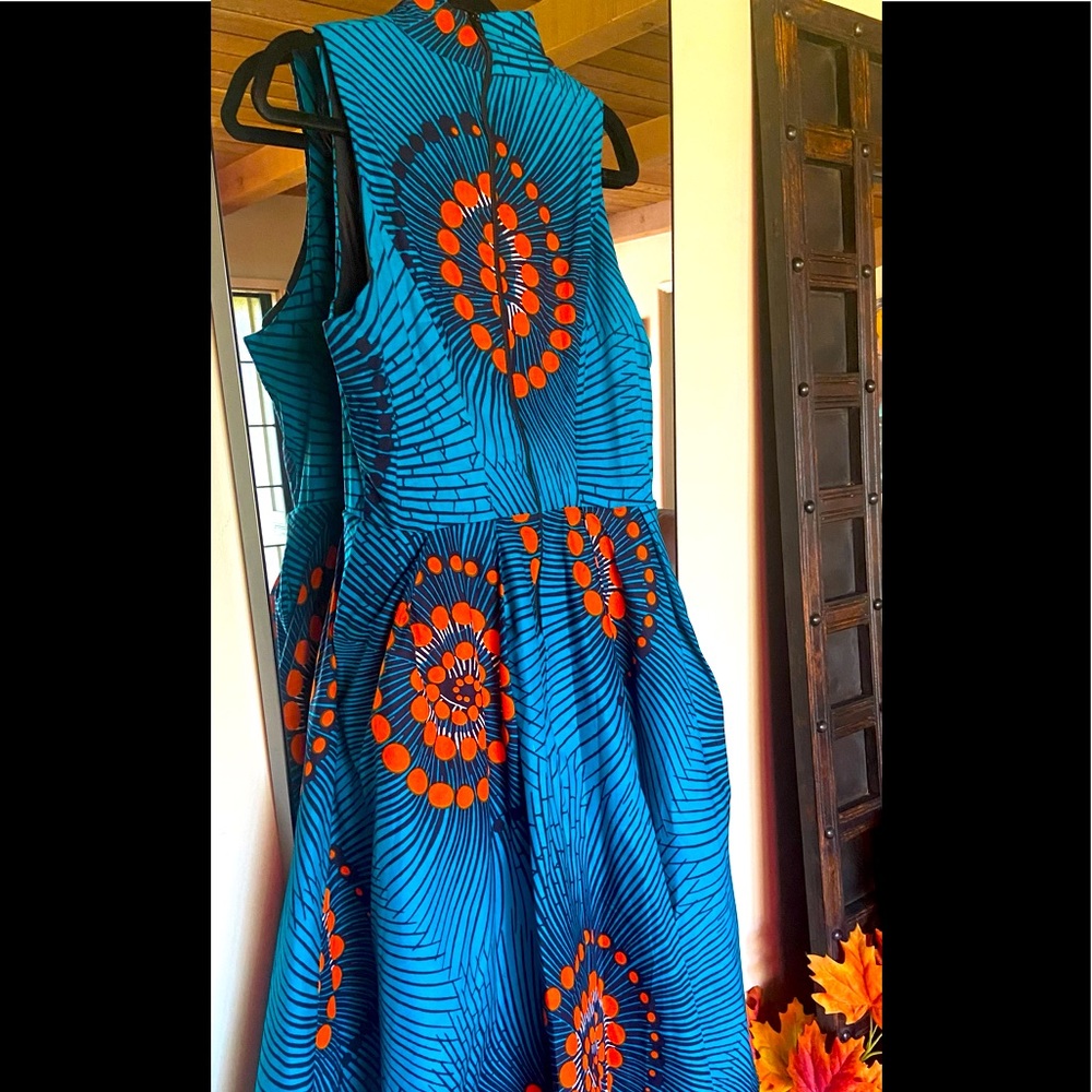 High low halter princess cut bodice A line dress with navy orange floral print.